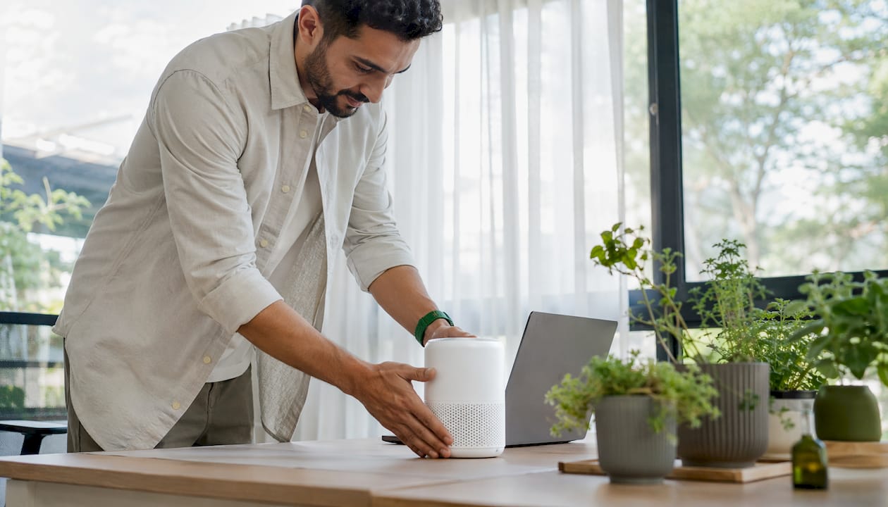Man placing air purifier on office desk
