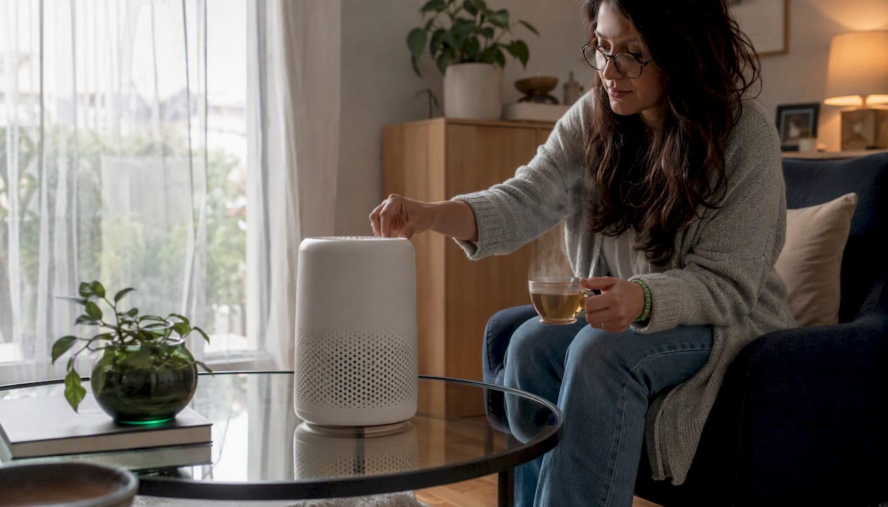 Woman setting portable air purifier